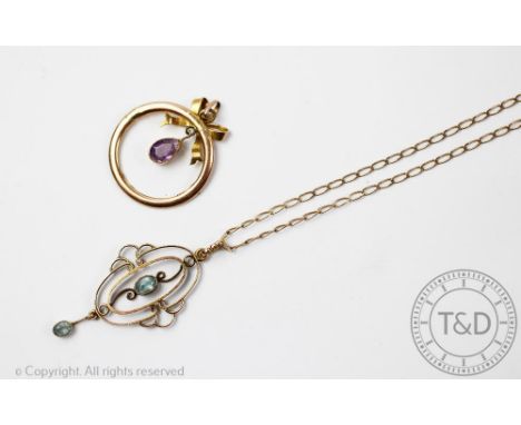 A topaz set pendant, early 20th century, the oval pendant centred by a central topaz and suspending a topaz set drop, all set