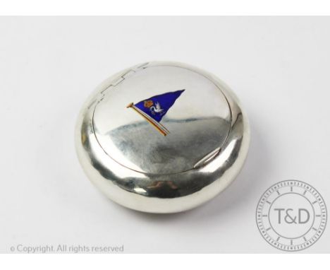 A silver and enamel snuff box, Birmingham 1911, the circular box with hinged cover centrally enamelled with a crest and openi