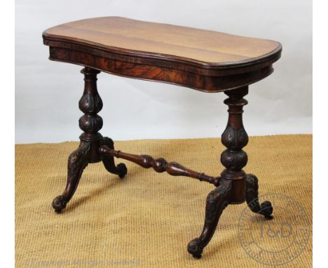 A Victorian walnut card table, with serpentine top, on carved legs (at fault), 71cm H x 91cm W x 46cm D