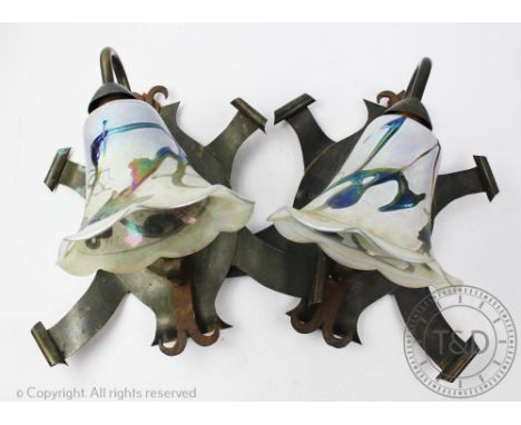 A pair of Arts and Crafts style wrought iron and brass wall lights, of foliate form, with mottled glass shades, 38cm high (2)