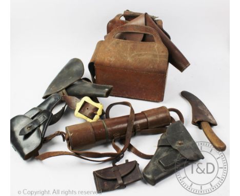 An early 20th century tan leather ammunition case, with three World War I tan leather pistol holsters, a black leather pistol