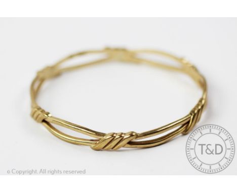 A 9ct yellow gold bangle of entwined form, sponsors mark 'CWS', gross weight 19.5gms 