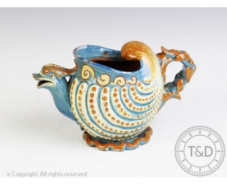 A C H Brannam Barum nautilus shape teapot with grotesque bird spout decorated in tones of blue, green and brown, incised scri