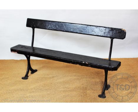 A late Victorian cast iron and painted wood station type bench, 75cm H x 139cm W CONDITION REPORT: The wood sections to the s