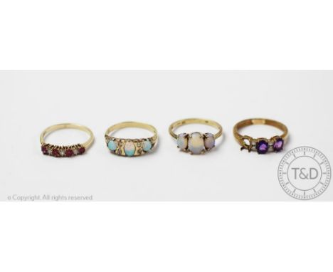 Four rings, to include; an opal and diamond ring in 9ct yellow gold, a three stone opal ring set in 9ct gold, an amethyst set