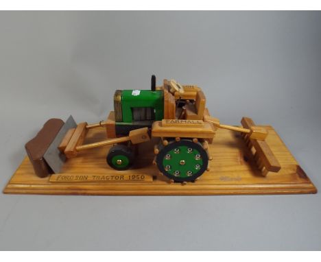A Wooden Fordson Tractor Model.
