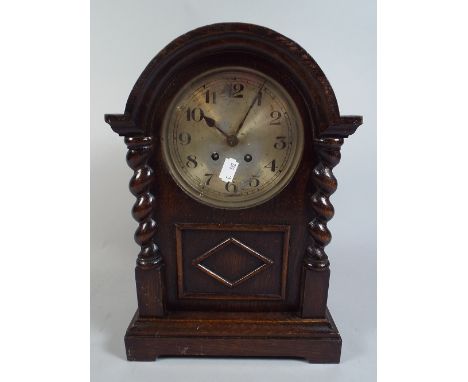 An Oak Barley Twist Mantel Clock with Eight Day Movement.