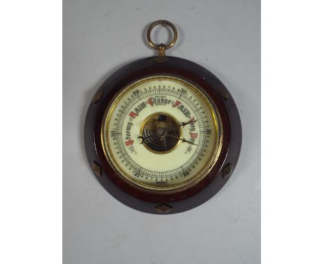 An Edwardian Circular Aneroid Barometer with Brass Mounts and Ring Handle.