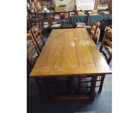 An Oak Refectory Style Plank Top Dining Table and Four Rush Seated Ladder Back Chairs. 