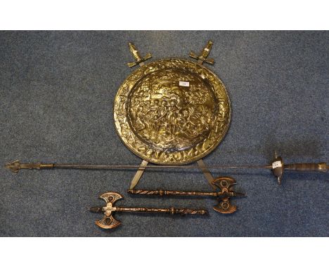 Repousse brass shield with pair of brass hilted, steel bladed swords, together with a stage prop type rapier with arrow head 