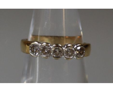 An 18ct gold five stone diamond ring.  Ring size K.  Approx weight 3.3g. (B.P. 21% + VAT) 