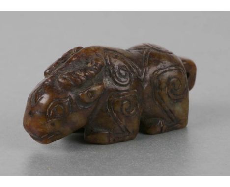 A Chinese carved russet jade carving of a ram with Archaic style engraving, 7cms long.