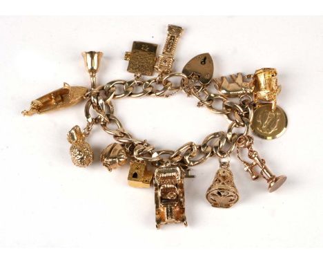 A 9ct gold charm bracelet with fourteen gold charms to include a motor car, a stick telephone, a windmill and a longcase cloc