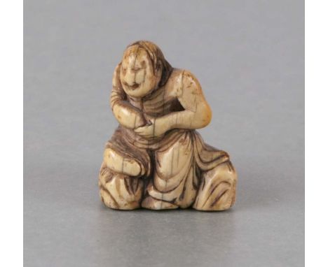 A 19th century Japanese ivory netsuke in the form of a seated man holding a gourd, 3.5cms high.