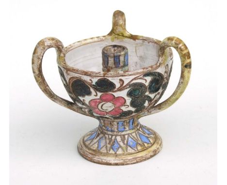 An Italian pottery three-handled candlestick with incised foliate decoration, 16cms high.