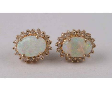 A pair of 14ct gold, opal and diamond stud earrings.