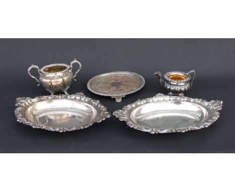 A quantity of silver plate to include a tureen, sugar bowls, wine coasters and trays.