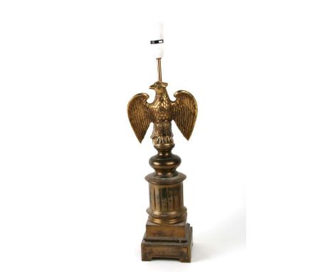 A French brass table lamp with an eagle with outstretched wings, overall 52cms high.