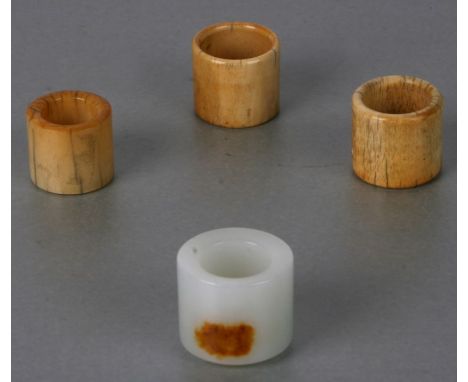 A Chinese jade / hardstone archer's ring; together with three Chinese ivory archer's rings (4).Condition ReportIvory ring has