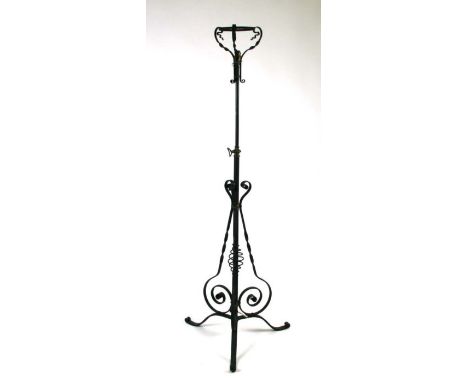 An Arts &amp; Crafts style wrought iron rise-and-fall standard lamp; together with a wrought iron conservatory heater (2).
