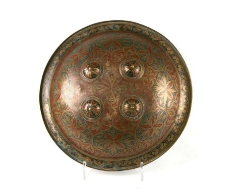 An Indian Dahl shield with finely engraved brass body highlighted with red and black enamel and four central bosses, 37cms da