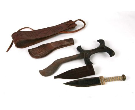 An African tribal hooked knife with steel blade and hardwood handle in a leather scabbard; together with another dagger in a 