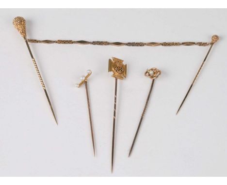 A double stick pin together with three gold stick pins to include a Wiltshire Regiment Emblem example (4). 