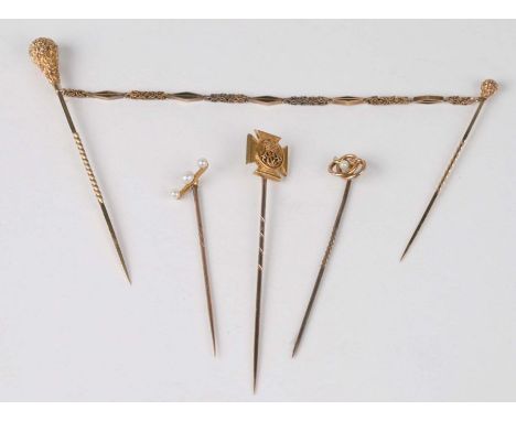 A double stick pin together with three gold stick pins to include a Wiltshire Regiment Emblem example (4). 