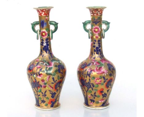 A pair of early 19th century Miles Mason vases, the Chinese clobbered style baluster bodies with tall slender necks with ring