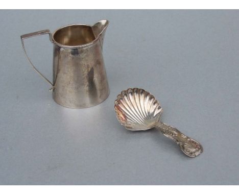 An Art Deco silver cream jug, maker's mark for Thomas Jones, Birmingham 1933; together with a William IV silver shell shaped 