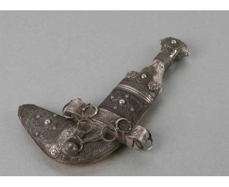 A Middle Eastern Jambiya dagger with white metal handle and scabbard, 19cms long.Condition ReportSome light rust to the blade