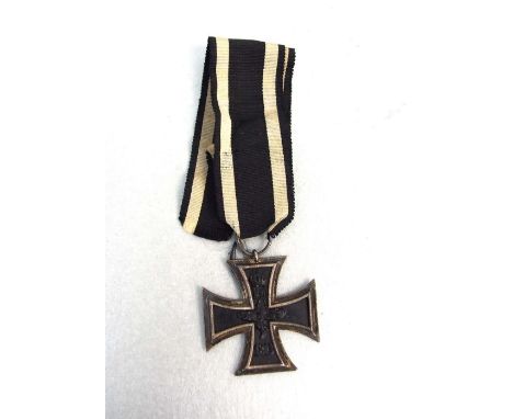 An original WW1 Imperial German Iron Cross 2nd Class with original ribbon. The ribbon suspension ring is correctly stamped.