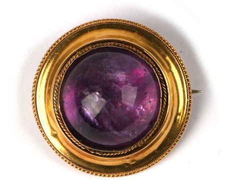 A yellow metal and large amethyst cabochon brooch with locket back. Total weight 21g