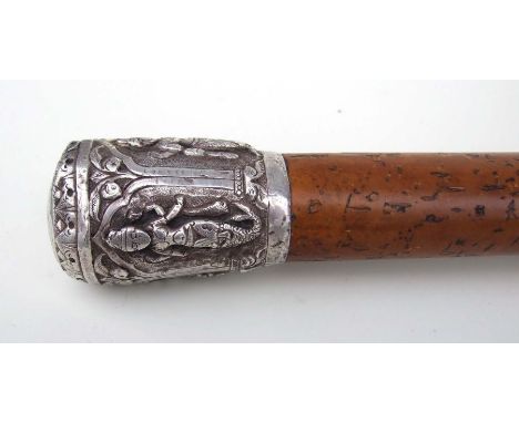 A Malacca walking stick with Burmese white metal figural pommel. 92cm lomg