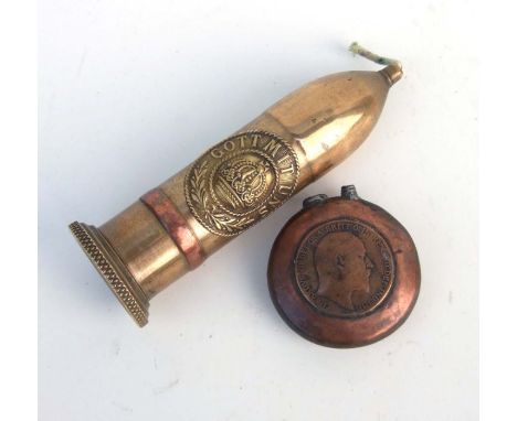 A WW1 trench art copper lighter A/F made with a 1917 penny, together with a trench art petrol candle with applied Imperial Ge