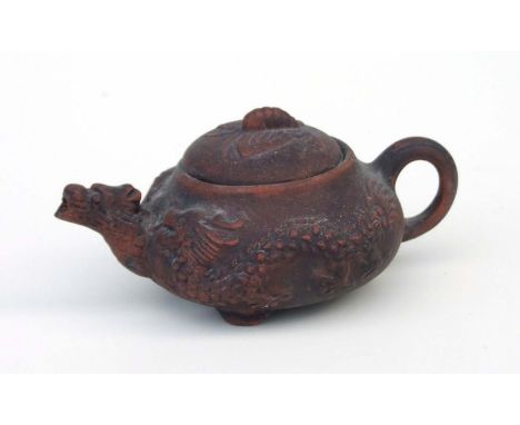 A Chinese Yixing pottery miniature teapot with dragon spout and butterfly finial, impressed seal mark to the underside, 5cms 