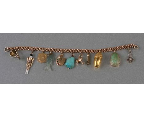A 9ct rose gold charm bracelet with eleven charms to include a 9ct gold articulated peg doll; a miniature whistle and Aladdin