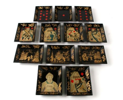A set of twelve early 19th century rectangular lacquer counter trays decorated with figures, playing cards and landscape scen