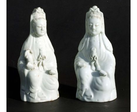 A pair of Chinese blanc de chine joss stick holders depicting Guanyin, 19cms high (2).