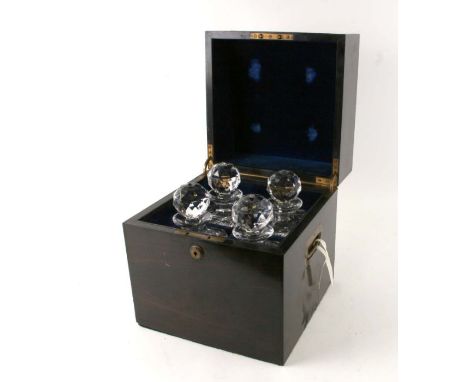 A 19th century coromandel four-division decanter box with a Brahma lock, the lid inset with a brass roundel with an armorial,