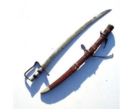 A Middle Eastern sabre in a snakeskin effect tooled leather scabbard, 83cms long.