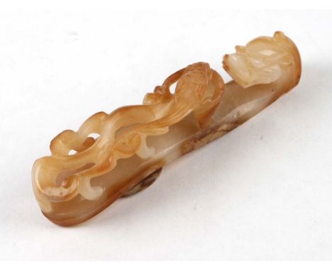 A Chinese russet jade / hardstone belt hook in the form of a dragon and chilong, 7.5cms long.Condition Reporthairline crack r