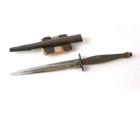 A Fairbairn-Sykes style commando knife by Marshall of Glasgow, with brass handle and leather scabbard, overall 32cms long, bl