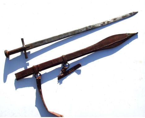 A Sudanese Islamic Kaskara sword in tooled brass mounted leather scabbard with shoulder straps, overall 101cms long.