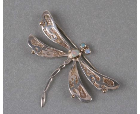 A white metal with yellow metal opal set dragonfly brooch. 6.5cm wide. 10.8g