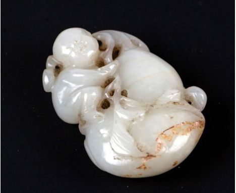 A Chinese mutton fat jade carving depicting a young boy climbing on a gourd, with incised signature, 5cms high.Condition Repo
