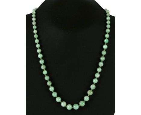 A Chinese graduated apple jade bead necklace, 52cms long.