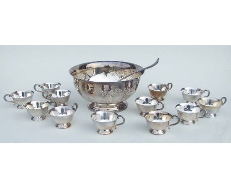 A George III style silver plated punch bowl, 30cms diameter and twelve matching cups and ladle; together with a silver plated