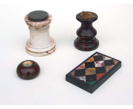 Four novelty desk top items to include a small sundial on red marble pedestal base; a compass inset on a shaped alabaster sta