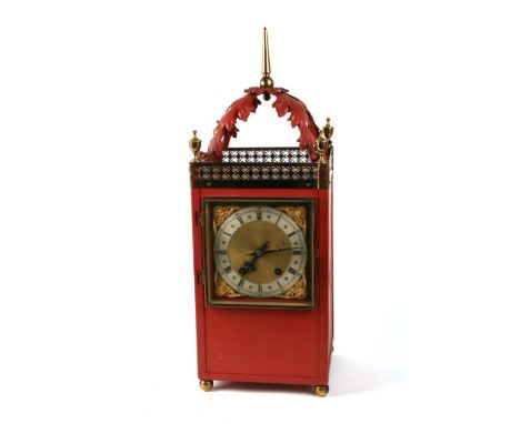 A red painted metal cased mantle clock with silvered chapter ring and Roman numerals, overall 59cms high.